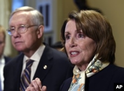 House Democratic Leader Nancy Pelosi of Calif., right, speaks as Senate Minority Leader Harry Reid of Nev., left, listens as she talks to reporters on Capitol Hill in Washington, Wednesday, Oct. 28, 2015.