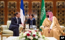 In this Nov. 9, 2017, photo released by Saudi Press Agency, SPA, Saudi Crown Prince Mohammed bin Salman meets with French President Emmanuel Macron upon his arrival in Riyadh, Saudi Arabia.