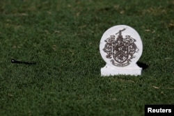 A Trump emblem marks the 17th tee box at Trump International Golf Club in West Palm Beach, Fla., Dec. 29, 2017.