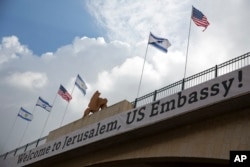 FILE - A sign is seen on a bridge leading to the U.S. Embassy compound ahead the official opening in Jerusalem, May 13, 2018.
