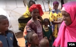 Abdiya Golicha, wearing pink, lives in northern Kenya's Marsabit County and volunteers to help Ethiopian refugees at the Dambala Fachana camp. (D. Gelmo/VOA)