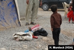 Families with almost nothing, but this boy's father managed to take out a couple of his geese and a toy in the Khazir Camp in the Kurdish region of northern Iraq, Oct. 28, 2016.
