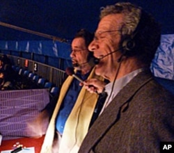 Big Apple Circus of the Senses co-founders Paul Binder and Michael Christensen describe the action as it happens for the visually impaired.