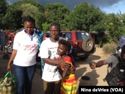 Kadiatu Bangura embraces her brother Emmanuel after being discharged from the Ebola Red Cross Treatment Center, Lumpa community, near Freetown, Sierra Leone, Sept. 27, 2014.