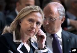 FILE - U.S. Secretary of State Hillary Clinton and French Foreign Minister Laurent Fabius attend the "Friends of Syria" conference in Paris, July 6, 2012.