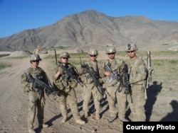 Sergeant Clayton Embre, far right, and Sergeant Devin Burgett, second from right, pose with comrades.