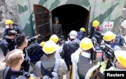 FILE - Journalists look around the third tunnel of Punggye-ri nuclear test ground before it is blown up during the dismantlement process in Punggye-ri, North Hamgyong Province, North Korea, May 24, 2018.