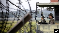 FILE - South Korean army soldiers stand guard at a military check point at the Imjingak Pavilion near the border village of Panmunjom, which has separated the two Koreas since the war.