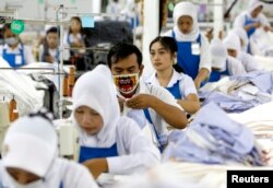 FILE - Seorang pekerja tengah menjahit celana panjang di PT Trisula Garmindo Manufacturing di Bandung, provinsi Jawa Barat, 17 September 2013. (REUTERS/Beawiharta)