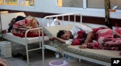 FILE - People are treated for suspected cholera infection at a hospital in Sana'a, Yemen, May. 15, 2017.