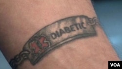 Electrician Ryan Merchant, a diabetic, finds a medical tattoo to be more practical and safer than the metal alert bracelet he used to wear. (VOA/A. Greenbaum)