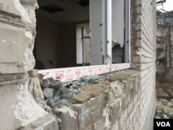 The glass appears freshly shattered, but is from the shelling of two years ago, Donetsk region, Ukraine, March 6, 2016. (L. Ramirez/VOA)