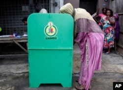 FILE - A woman casts her vote during a local government election in Lagos, Nigeria, July 22, 2017. The United States and Britain issued warnings against anyone who attempts violence or disruption during the 2019 elections.