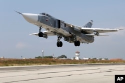 In this photo taken from Russian Defense Ministry official website on Oct. 6, 2015, a Russian SU-24M jet fighter takes off from an airbase Hmeimim in Syria.