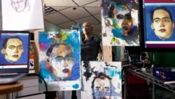 Humanoid robot Sophia, developed by Hanson Robotics, is reflected in a mirror between paintings before auctioning her own non-fungible token (NFT) artwork, in Hong Kong, China March 16, 2021. REUTERS/Tyrone Siu