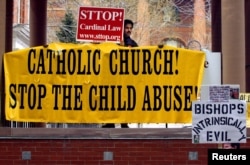 FILE – Demonstrators protest the release of an accused pedophile priest in Cambridge, Mass., in 2002. Italy’s Trento archdiocese sanctioned a priest who, in a TV interview, suggested young victims invited abuse, Oct. 6, 2015.