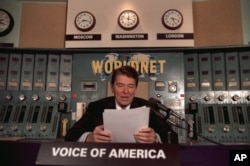 FILE - President Ronald Reagan gives his weekly radio address at the Voice of America studio in Washington, Nov. 9, 1985.