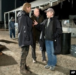 Left to right: Chris Hemsworth (as Thor), Stellan Skarsgård (as Selvig), and director Kenneth Branagh discuss a scene on the set of THOR, from Paramount Pictures and Marvel Entertainment.