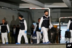 Turkish police crime scene investigators leave an underground car park, after looking for possible clues into the killing of Saudi journalist Jamal Khashoggi, on a vehicle belonging to the Saudi Consulate found by authorities a day earlier, in Istanbul, Oct. 23, 2018.