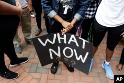 FILE - Students at the University of North Carolina-Charlotte hold a vigil following Tuesday's police shooting of Keith Lamont Scott at The Village at College Downs apartment complex in Charlotte, N.C., Sept. 21, 2016.