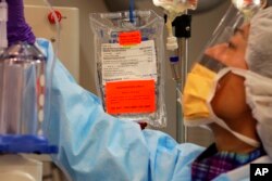 FILE - Chemotherapy medicine is readied for a liver cancer patient at the National Institutes of Health in Bethesda, Md., March 24, 2009.
