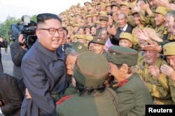 FILE - North Korean leader Kim Jong Un meets participants of the 5th National Conference of War Veterans in this undated photo released by North Korea's Korean Central News Agency (KCNA) on July 27, 2018.