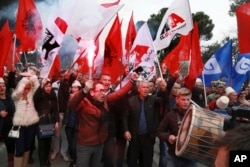 FILE - Supporters of the Albanian main opposition Democratic Party chant slogans during a protest in front of the government building in Tirana, Albania, Feb. 18, 2017.