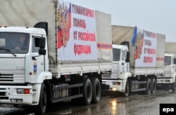 Russia -- Trucks of a Russian aid convoy carrying banners reading 'Humanitarian help from Russian Federation' wait for departure to Ukraine in Rostov region, December 11, 2014.