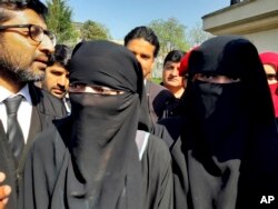 Pakistani girls from the Hindu community wearing black veils, arrive at a court in Islamabad, Pakistan, March 26, 2019.