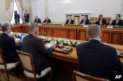 Russian President Vladimir Putin, fourth right in the back, meets with heads of international news agencies at the St. Petersburg International Economic Forum in St. Petersburg, Russia, June 1, 2017.