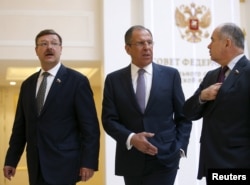 Russian Foreign Minister Sergei Lavrov, center, Konstantin Kosachyov, left, Chairman of the Federation Council Committee on Foreign Affairs, and Ilyas Umakhanov, Deputy Chairman of the Federation Council, leave a session of the Federation Council in Moscow, May 20, 2015.