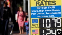 FILE - A board advertises the exchange rate in London, Aug. 24, 2018.