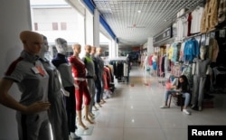 A vendor has her dinner in a mall on the Chinese side of the China-Kazakhstan Khorgos International Border Cooperation Center (ICBC), in Khorgos, China, May 12, 2017.