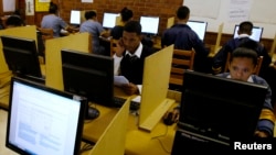 FILE - Students use computers to study at a secondary school in Cape Town, South Africa, Nov. 7, 2013. The World Bank estimates that 70 percent of Africans leave school without the basic skills they need to compete.