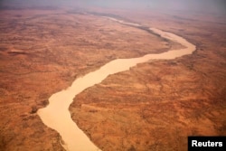 A dried up river filled with sand winds its way across the desert near Gos Beida in eastern Chad, June 5, 2008.