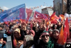 People listen to Turkey's President Recep Tayyip Erdogan during a rally of his ruling Justice and Development Party (AKP), in Ankara, Turkey, March 14, 2019, ahead of local elections scheduled for March 31.