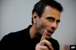 FILE - Venezuela's opposition leader Henrique Capriles speaks during an interview at his office in Caracas, Venezuela, July 30, 2018.