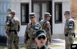 FILE - South Korean and U.S. soldiers stand in the southern side during a press tour at the border village of Panmunjom in the Demilitarized Zone, South Korea, April 18, 2018.