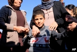 Dilbar Ali Ravu, 10, is reunited with his family in Iraq after five years of captivity with the Islamic State group, March 2, 2019.