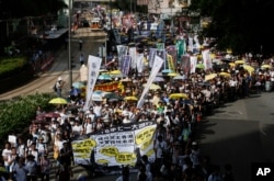 FILE - Pro-democracy protesters march during an annual protest marking Hong Kong's handover from British to Chinese rule in 1997 in Hong Kong, Wednesday, July 1, 2015. In 2014, millions of pro-democracy protesters blocked Hong Kong’s streets for several weeks.