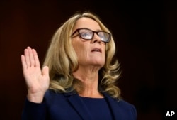 FILE - Christine Blasey Ford is sworn in before the Senate Judiciary Committee, Sept. 27, 2018, on Capitol Hill in Washington.