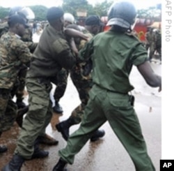 Guinea's military leads away protesters during violent government crackdown at a Conakry soccer stadium. 28 Sep 2009