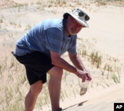 Geologist Michael Welland collects sand samples in central California.
