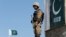 FILE - A Pakistani soldier stands guard at the Angoor Adda outpost along Pakistan's border with Afghanistan, in South Waziristan, Pakistan Oct. 18, 2017.