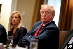 President Donald Trump listens during a meeting with law enforcement officials on the MS-13 street gang and border security, in the Cabinet Room of the White House, Feb. 6, 2018.
