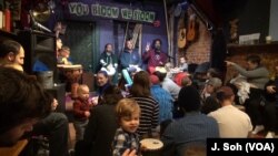 Parents and children take in the music, movement and message of peace at Baba Ras D's Harambee program in Washington.