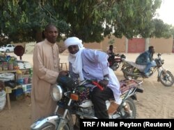 Local men pose for a photo on a downtown street corner, Agadez, Niger, Feb. 20, 2018.