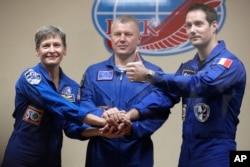 French astronaut Thomas Pesquet (right) Russian cosmonaut Oleg Novitsky and U.S. astronaut Peggy Whitson, members of the main crew to the International Space Station, pose after a news conference in Russian leased Baikonur cosmodrome, Kazakhstan, Nov. 16, 2016.