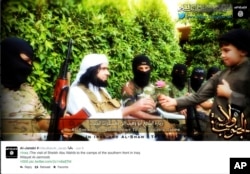 FILE - This screen grab from an Islamic State group affiliated Twitter account, taken Sunday, Sept. 20, 2014, purports to show senior military commander Abu Wahib handing a flower to a child while visiting southern Iraq, as part of the group's broad social media campaign.