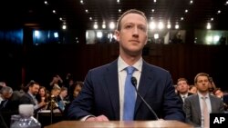 Facebook CEO Mark Zuckerberg arrives to testify before a joint hearing of the Commerce and Judiciary Committees on Capitol Hill in Washington, Tuesday, April 10, 2018, about the use of Facebook data to target American voters in the 2016 election.